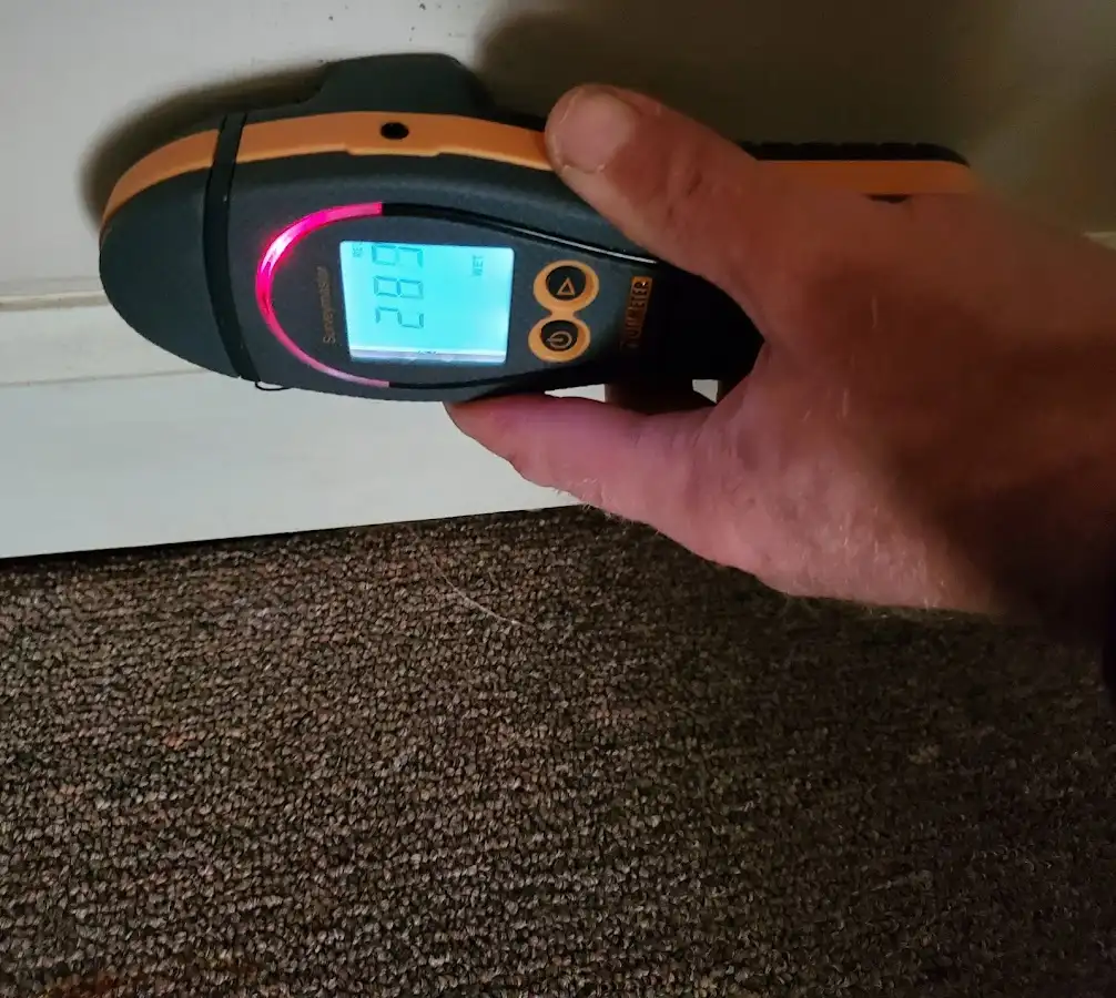 Moisture detection at baseboard during Storm Damage Restoration in Sky Lake